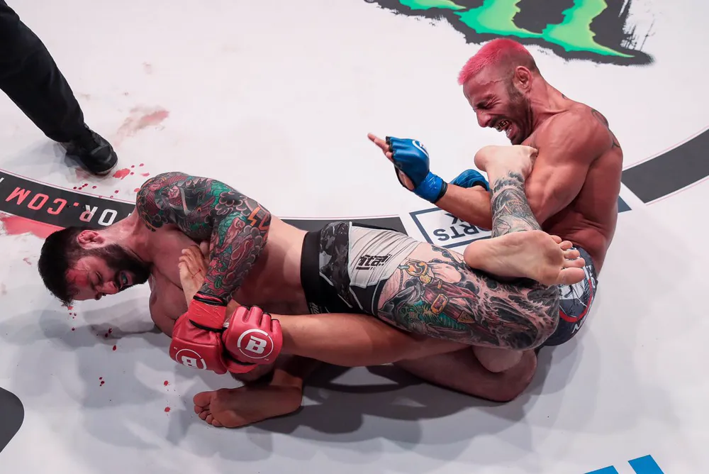 Lewis Long grappling in the cage