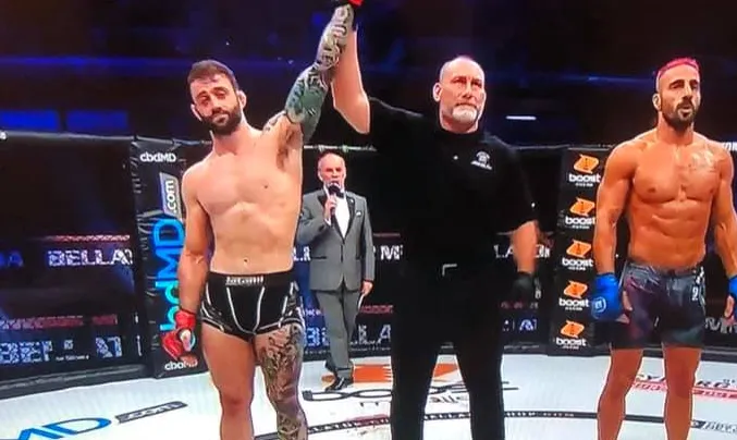 Lewis Long with his hand raised after a Bellator win